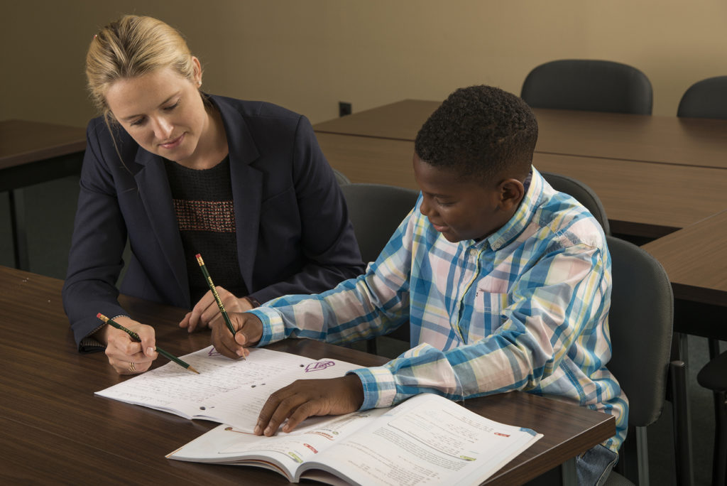 A tutor at Huntington Learning Center franchise helps a student.